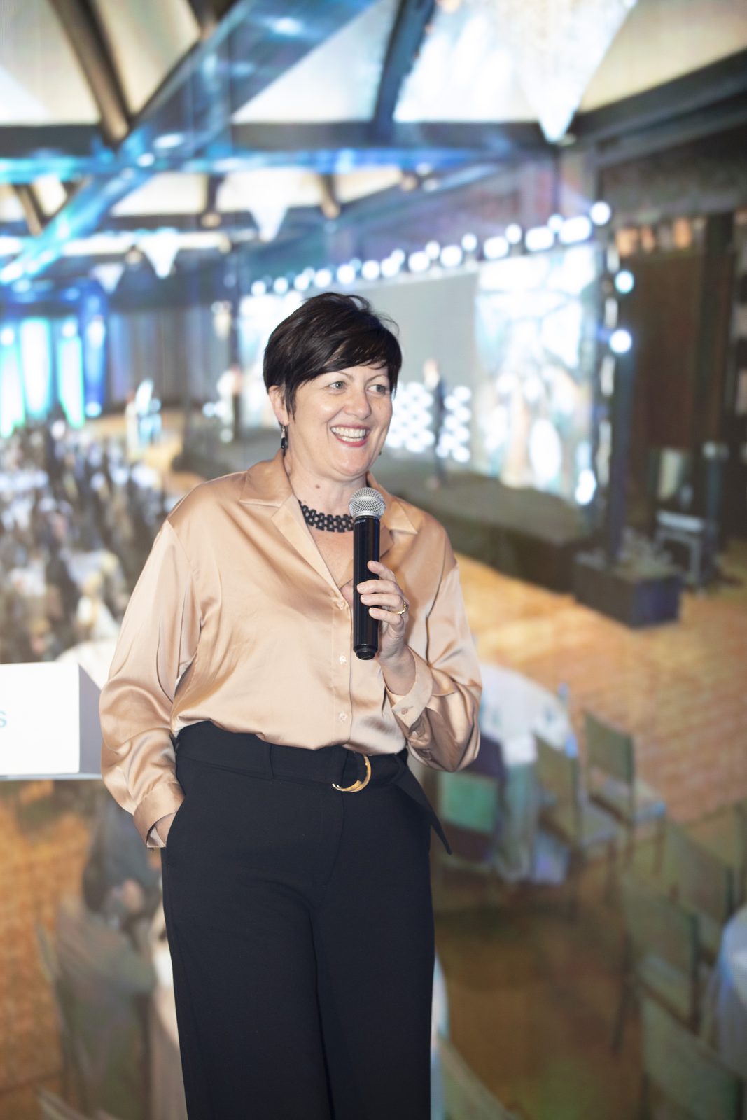 Maria Spies speaking with a handheld microphone